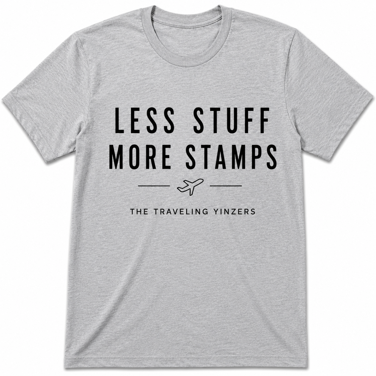Grey t-shirt with Less Stuff More Stamps text and airplane graphic by The Traveling Yinzers